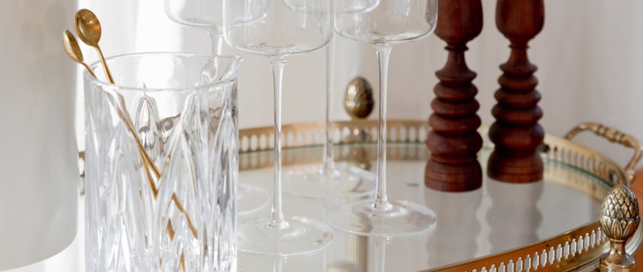 Entertainment cart with crystal wine glasses and gold spoons